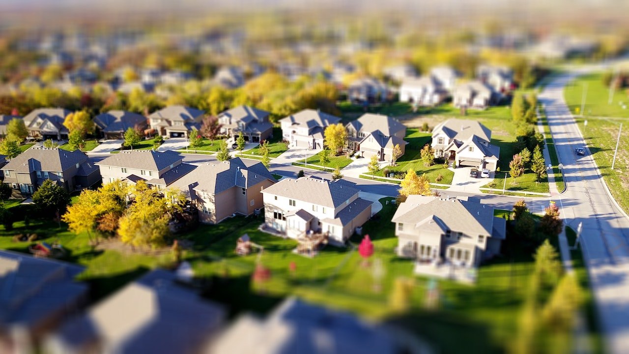 Aerial view of a suburban neighborhood with tidy homes and green lawns