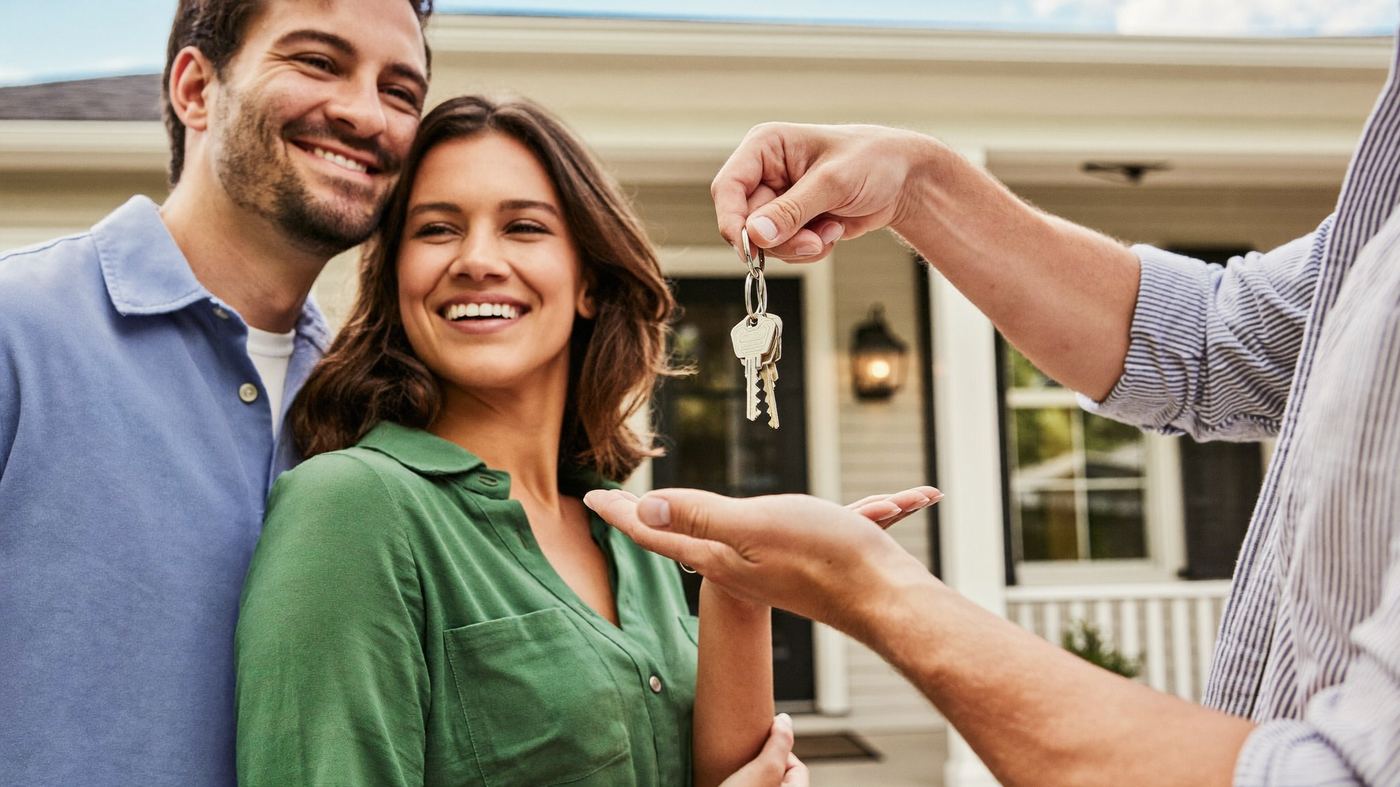Family receiving keys to their new rental home